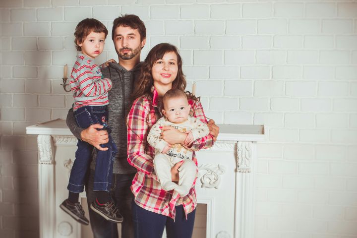 Standing Family Near Fireplace